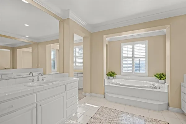 a white bath tub sitting in a bathroom next to a window