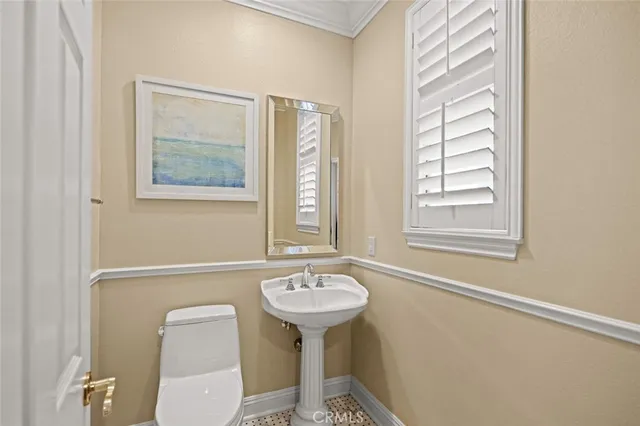 a bathroom with a sink a mirror and a toilet