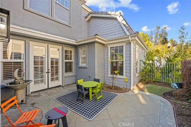 a view of house with a chairs and table in a patio