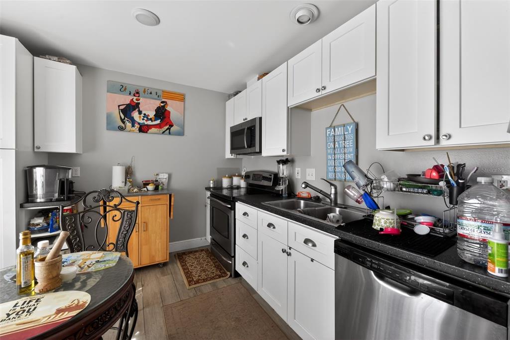 4154 16th Street East, Unit 15 Ellenton, FL 34222 - Photo 12 of 31 a kitchen with a sink stove and cabinets