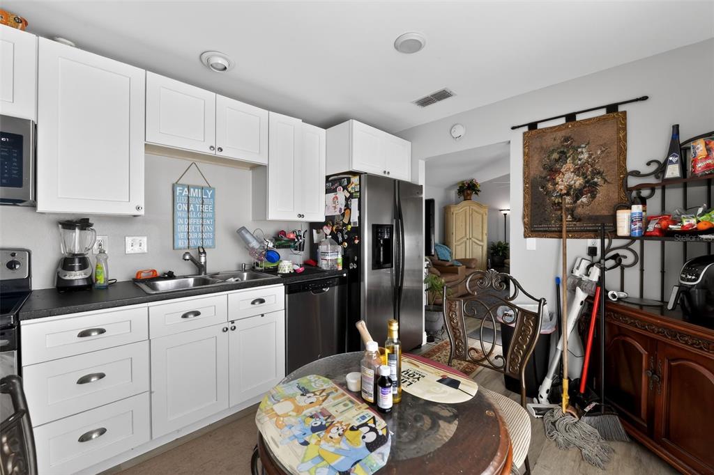 4154 16th Street East, Unit 15 Ellenton, FL 34222 - Photo 13 of 31 a kitchen with stainless steel appliances granite countertop a refrigerator and a stove top oven