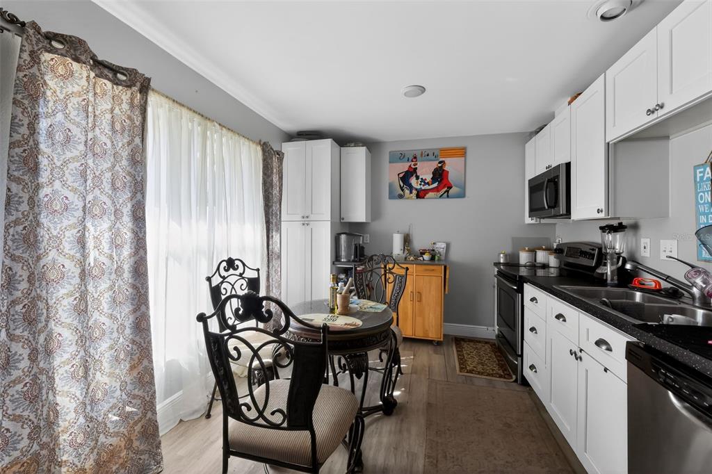 4154 16th Street East, Unit 15 Ellenton, FL 34222 - Photo 15 of 31 a kitchen with stainless steel appliances a table and chairs in it