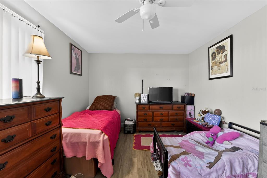 4154 16th Street East, Unit 15 Ellenton, FL 34222 - Photo 18 of 31 a bedroom with a bed and wooden floor