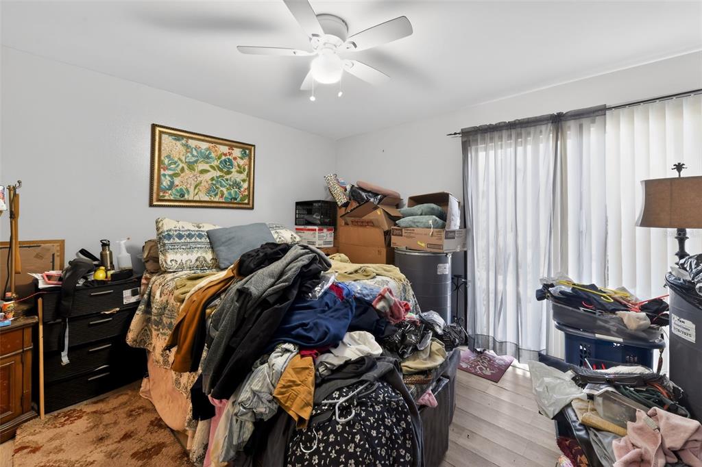 4154 16th Street East, Unit 15 Ellenton, FL 34222 - Photo 22 of 31 a bedroom with a bed and wooden floor
