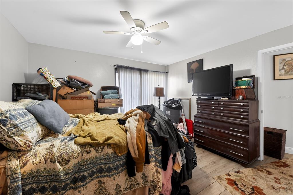 4154 16th Street East, Unit 15 Ellenton, FL 34222 - Photo 27 of 31 a bed room with bed and a flat screen tv