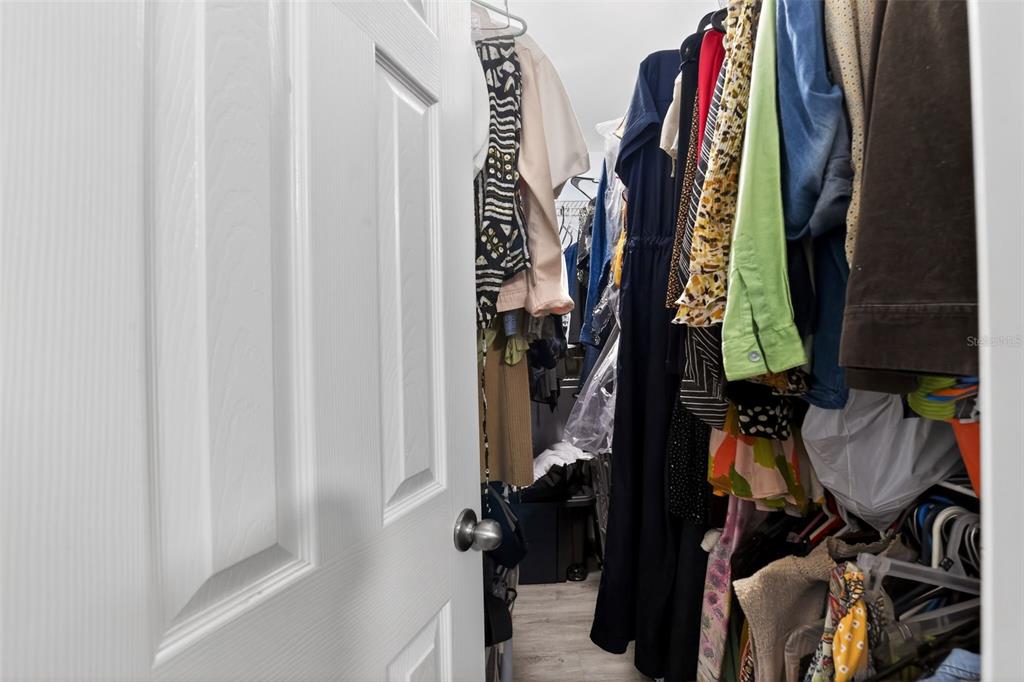 4154 16th Street East, Unit 15 Ellenton, FL 34222 - Photo 30 of 31 a view of walk in closet with clothes and shoes