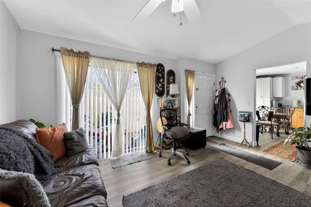a living room with furniture a rug and a large window