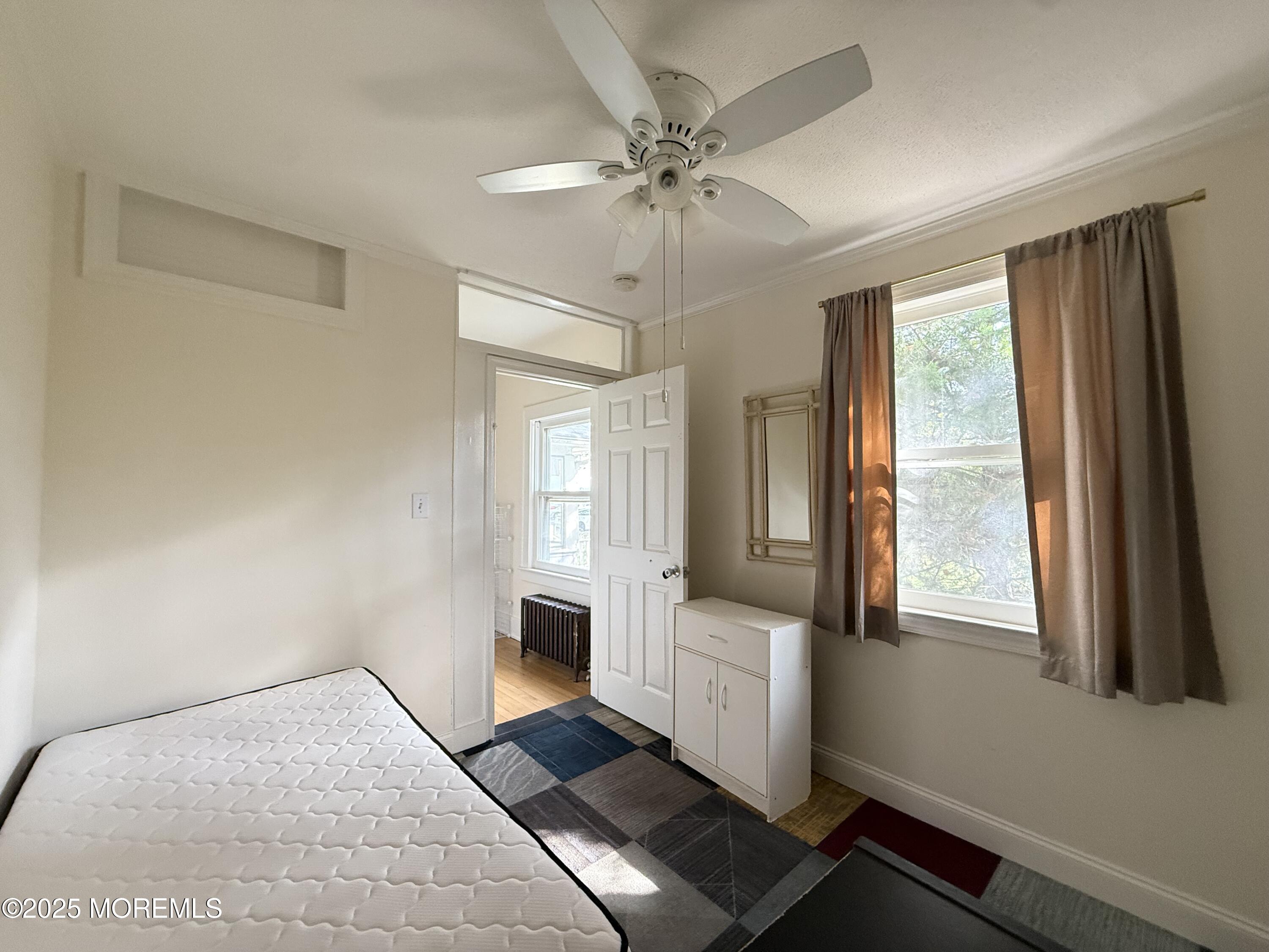 210 Lincoln Avenue, Unit WINTER 25 Long Branch, NJ 07740 - Photo 11 of 38 a bedroom with a bed and window