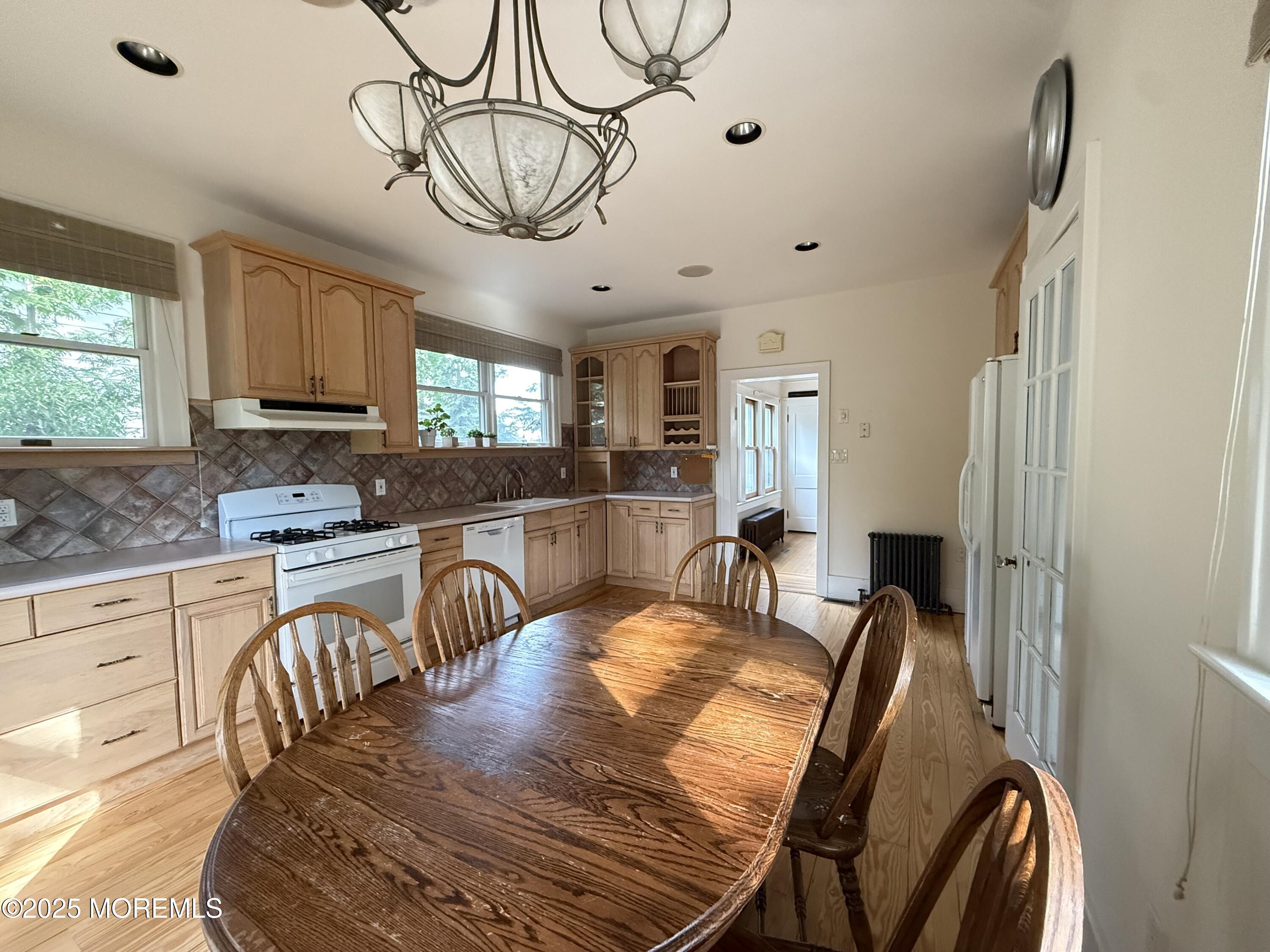 210 Lincoln Avenue, Unit WINTER 25 Long Branch, NJ 07740 - Photo 13 of 38 a view of a dining area with furniture window and wooden floor