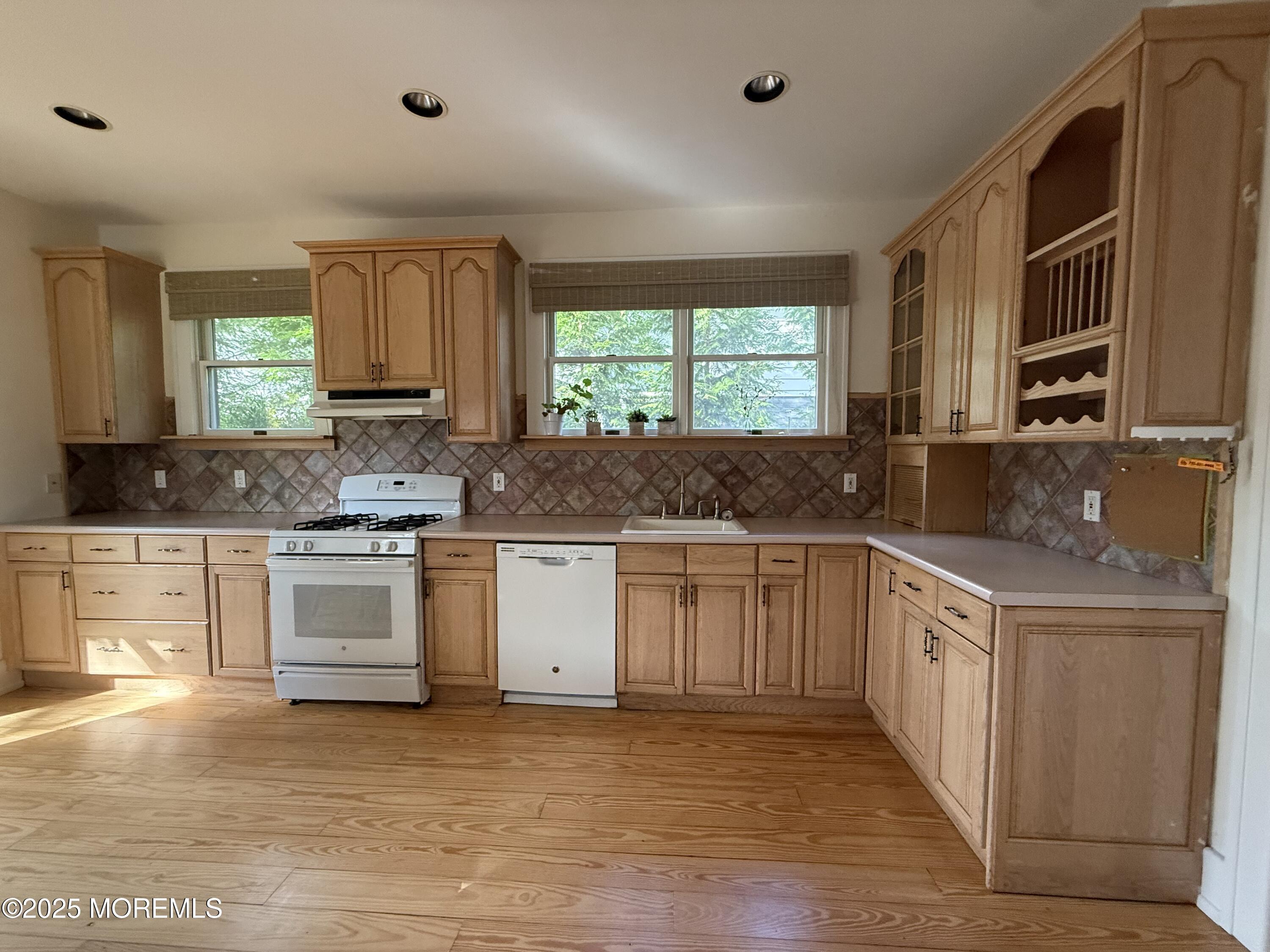 210 Lincoln Avenue, Unit WINTER 25 Long Branch, NJ 07740 - Photo 16 of 38 a kitchen with stainless steel appliances white cabinets a sink and a stove