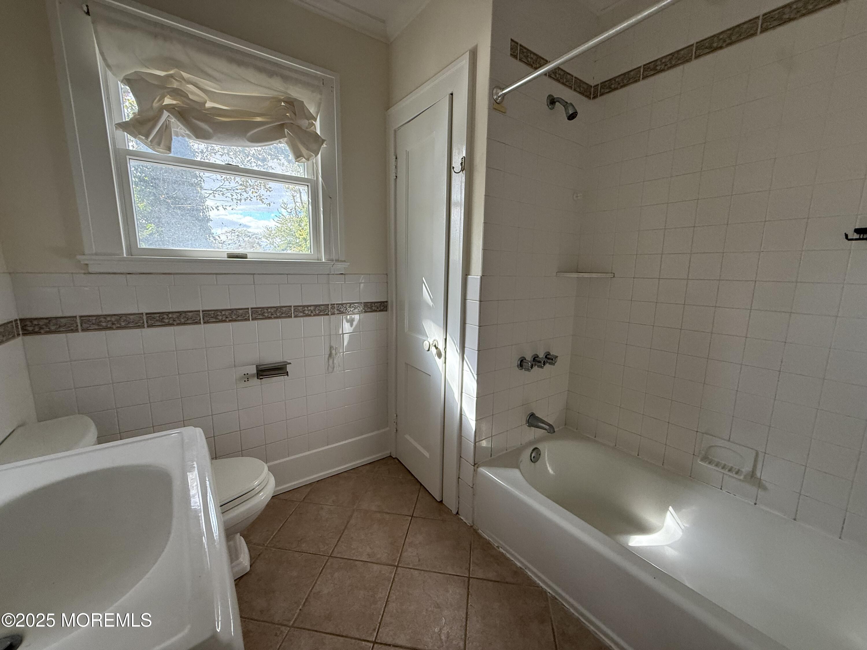 210 Lincoln Avenue, Unit WINTER 25 Long Branch, NJ 07740 - Photo 19 of 38 a bathroom with a tub a toilet and a sink