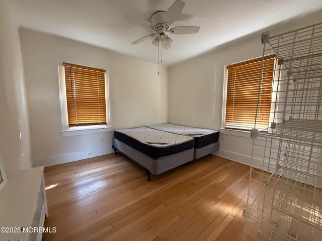 a spacious bedroom with a bed and a window
