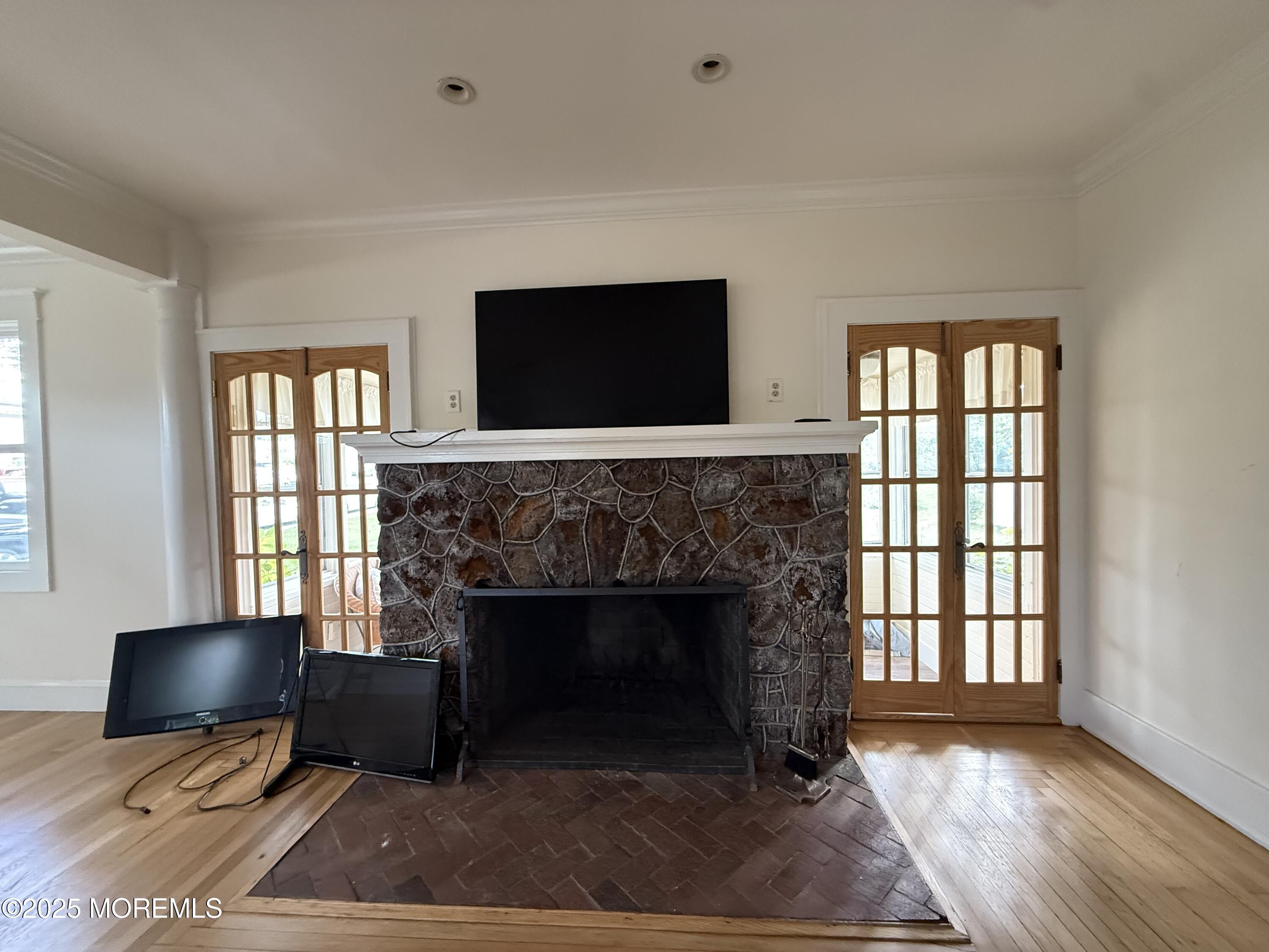 210 Lincoln Avenue, Unit WINTER 25 Long Branch, NJ 07740 - Photo 5 of 38 a living room with furniture a flat screen tv and a fireplace