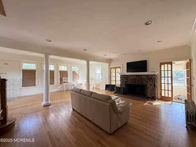 a view of a dining room with furniture window and wooden floor