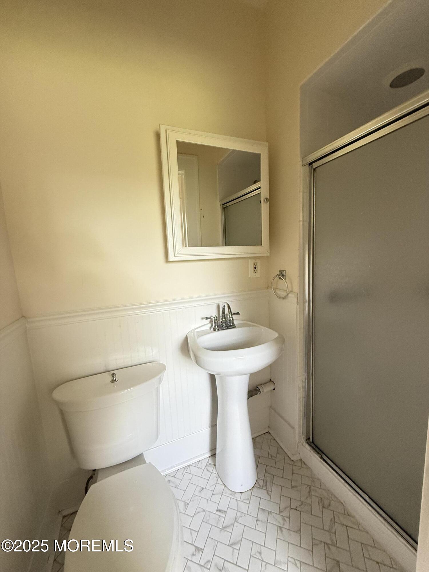 210 Lincoln Avenue, Unit WINTER 25 Long Branch, NJ 07740 - Photo 9 of 38 a bathroom with a sink a toilet and mirror