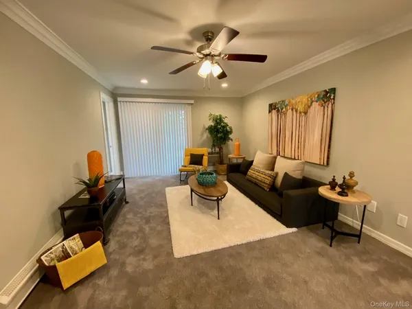 a living room with furniture and a chandelier