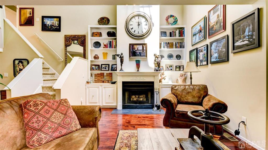 449 Sayre Drive Plainsboro, NJ 08540 - Photo 11 of 58 a living room with furniture a clock and a fireplace