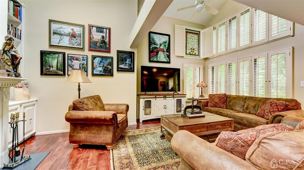 449 Sayre Drive Plainsboro, NJ 08540 - Photo 12 of 58 a living room with furniture a flat screen tv and a fireplace