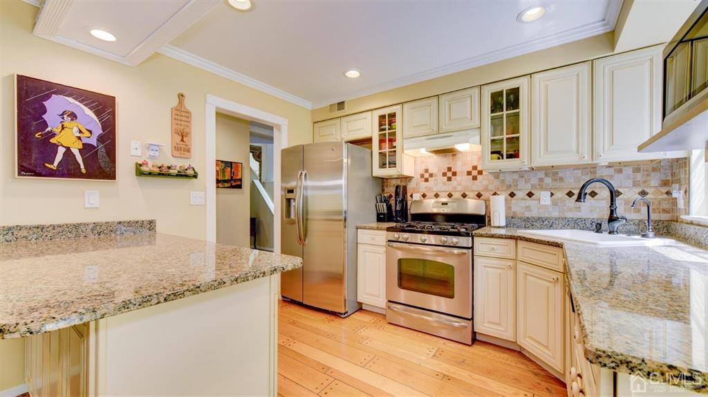 449 Sayre Drive Plainsboro, NJ 08540 - Photo 22 of 58 a kitchen with stainless steel appliances granite countertop a stove a sink and a refrigerator