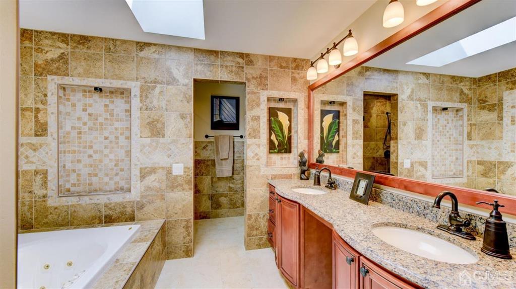 449 Sayre Drive Plainsboro, NJ 08540 - Photo 38 of 58 a bathroom with a granite countertop tub sink and mirror