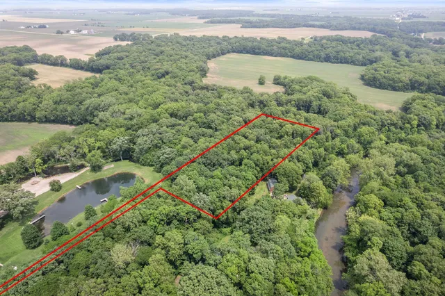 a view of a green yard with a lake view