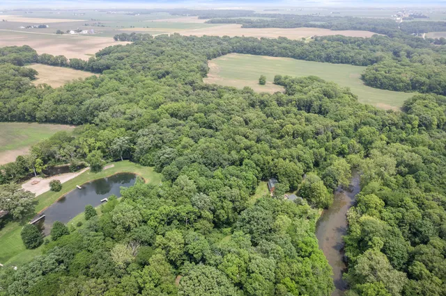 an aerial view of a houses with a lake view