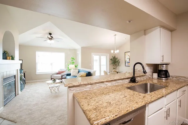 a living room with granite countertop furniture and fireplace