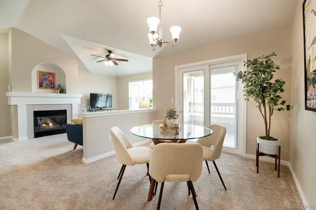 a dining room with furniture a chandelier and window