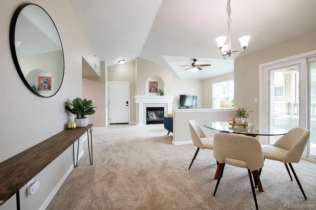 a view of a livingroom with furniture a fireplace and chandelier
