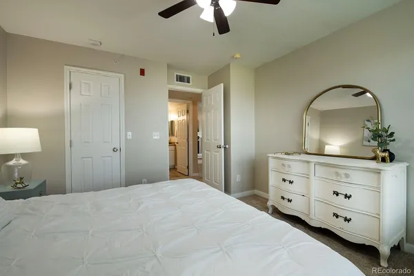 a bedroom with a bed and a dresser
