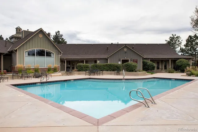 a view of a patio with couches chairs and swimming pool with a yard