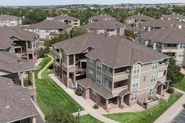 an aerial view of multiple houses with a big yard