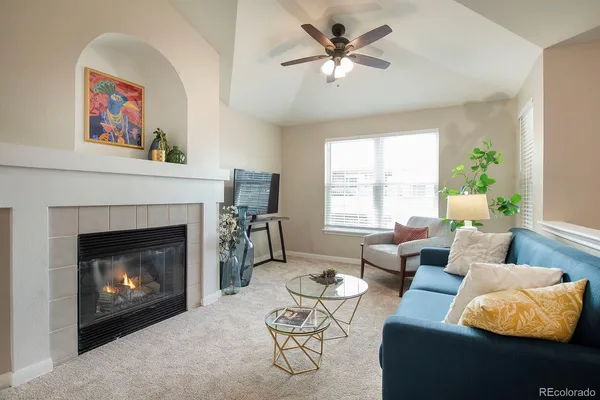 a living room with furniture and a fireplace