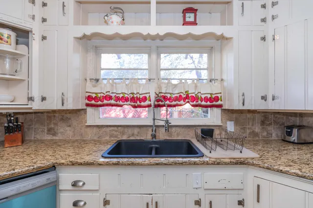 a kitchen with stainless steel appliances granite countertop a sink and cabinets