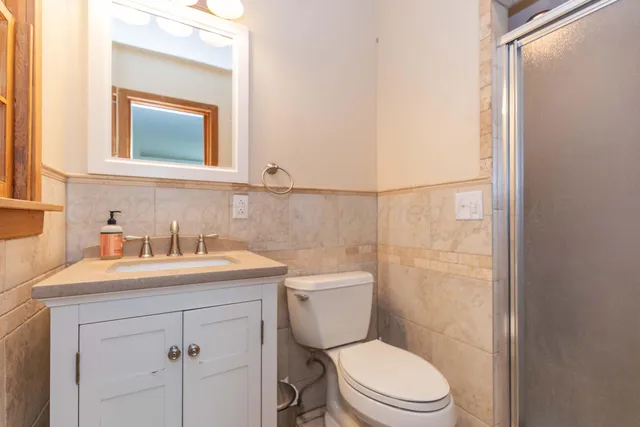 a bathroom with a sink vanity and mirror