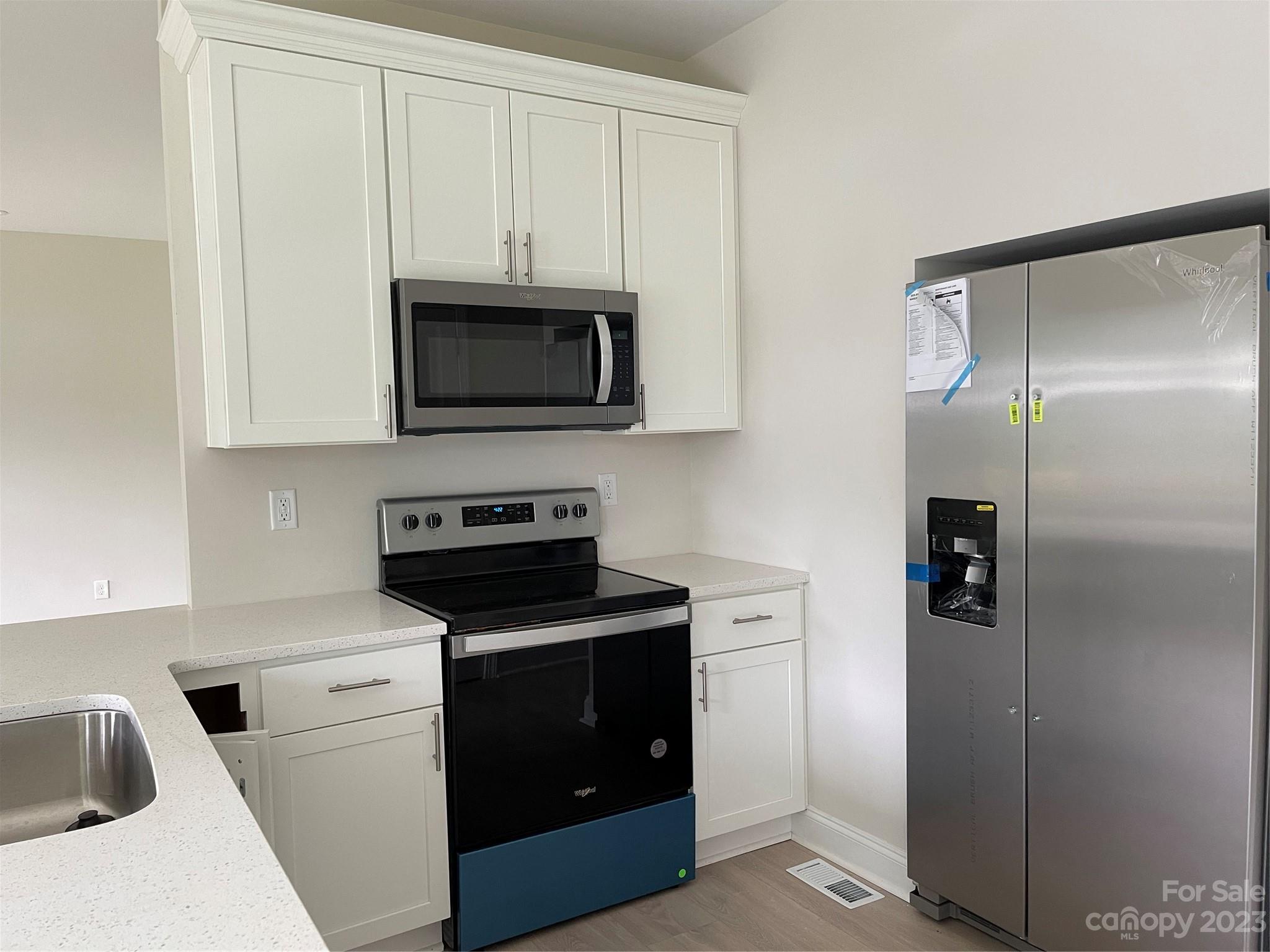 525 State Road 696 Chester, SC 29706 - Photo 5 of 10 a kitchen with white cabinets and stainless steel appliances