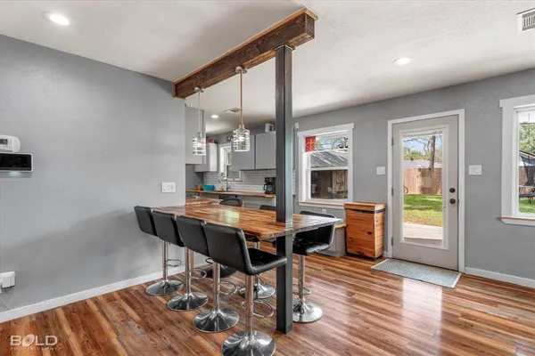 a room with stainless steel appliances furniture and a kitchen view