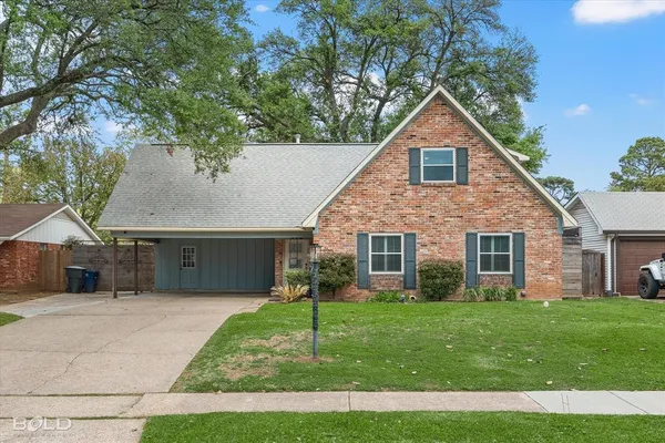 a front view of house with yard and green space
