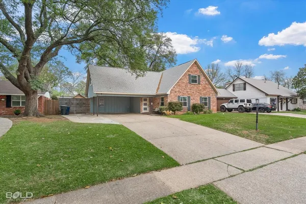 a front view of house with yard and green space