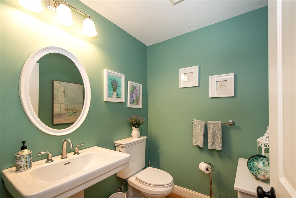 18 Kevin's Way, Unit 18 Scituate, MA 02066 - Photo 11 of 33 a bathroom with a toilet a sink and mirror