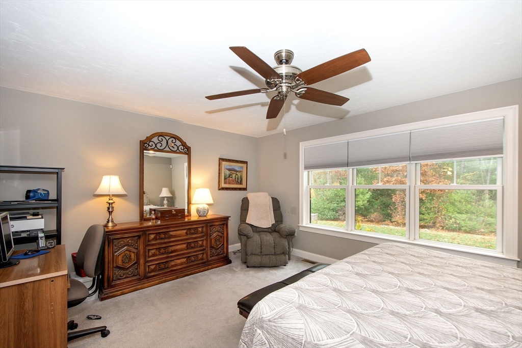 18 Kevin's Way, Unit 18 Scituate, MA 02066 - Photo 13 of 33 a bedroom with a bed and a chandelier