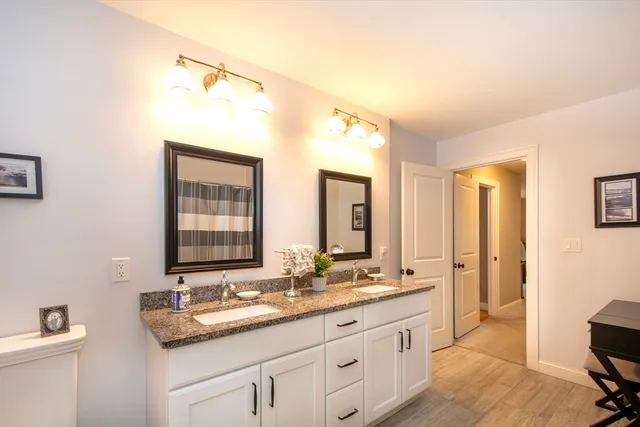 a bathroom with a granite countertop sink mirror and double