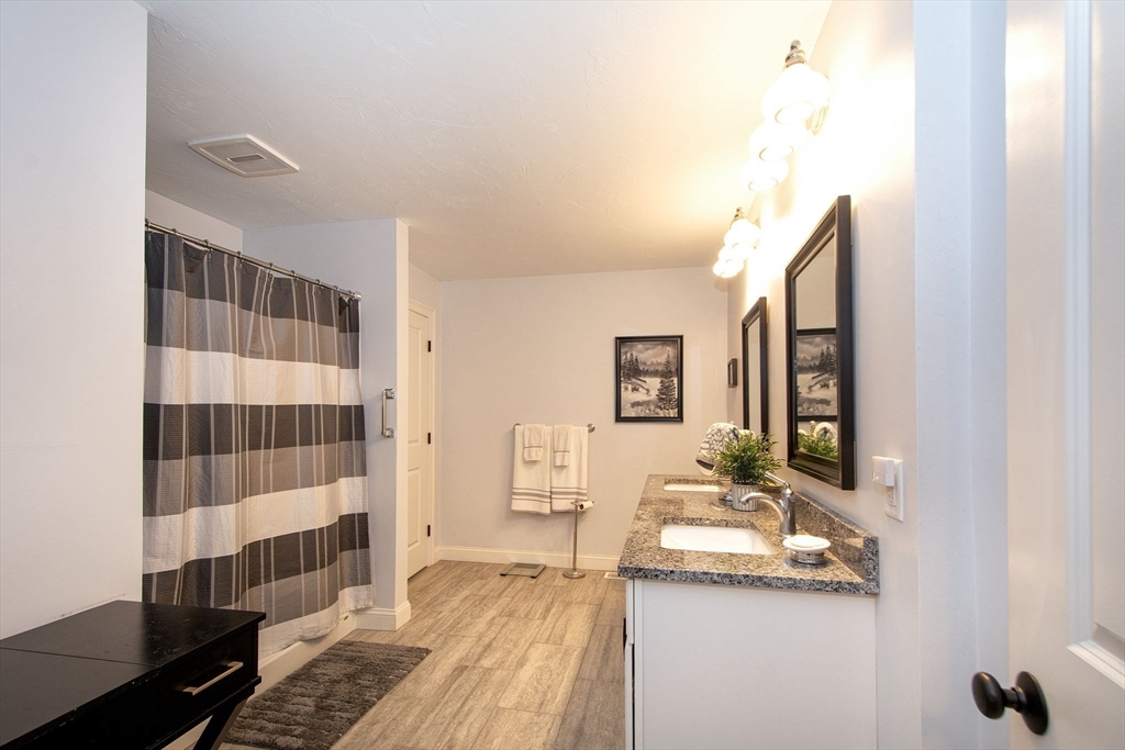 18 Kevin's Way, Unit 18 Scituate, MA 02066 - Photo 15 of 33 a bathroom with a sink and a mirror