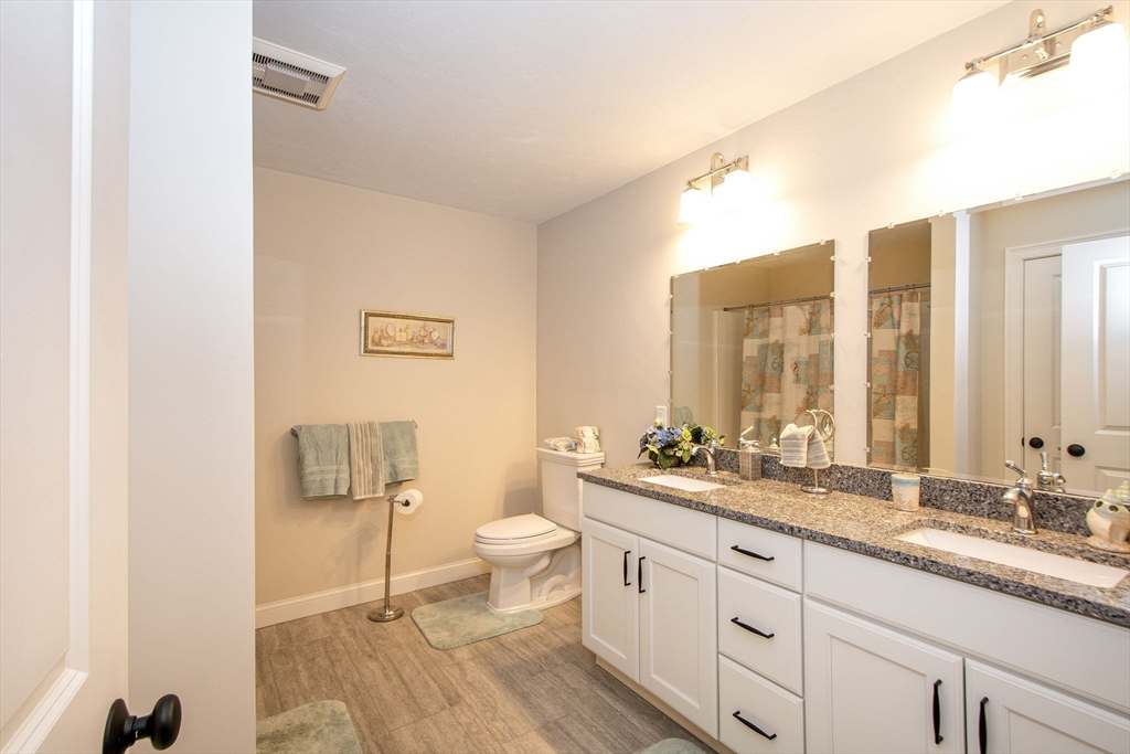 18 Kevin's Way, Unit 18 Scituate, MA 02066 - Photo 18 of 33 a bathroom with a double vanity sink toilet and a mirror
