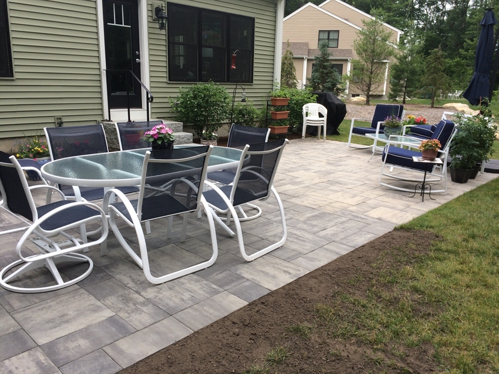 18 Kevin's Way, Unit 18 Scituate, MA 02066 - Photo 30 of 33 a view of a patio with table and chairs and potted plants