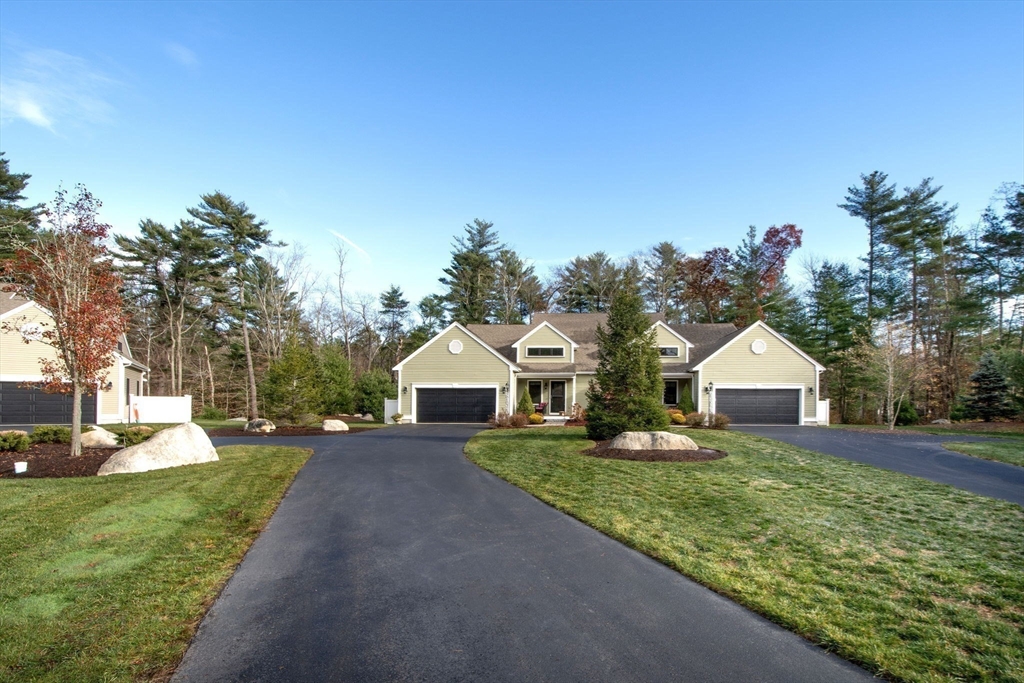 18 Kevin's Way, Unit 18 Scituate, MA 02066 - Photo 33 of 33 a front view of a house with a yard and trees