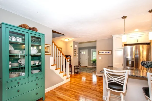 a living room with furniture a wooden floor and next to a window