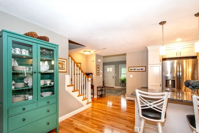 a living room with furniture a wooden floor and next to a window