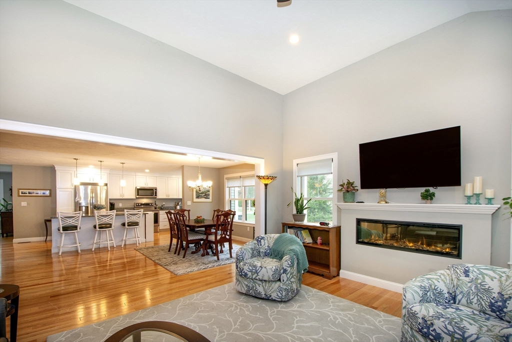 18 Kevin's Way, Unit 18 Scituate, MA 02066 - Photo 10 of 33 a living room with furniture a flat screen tv and a fireplace