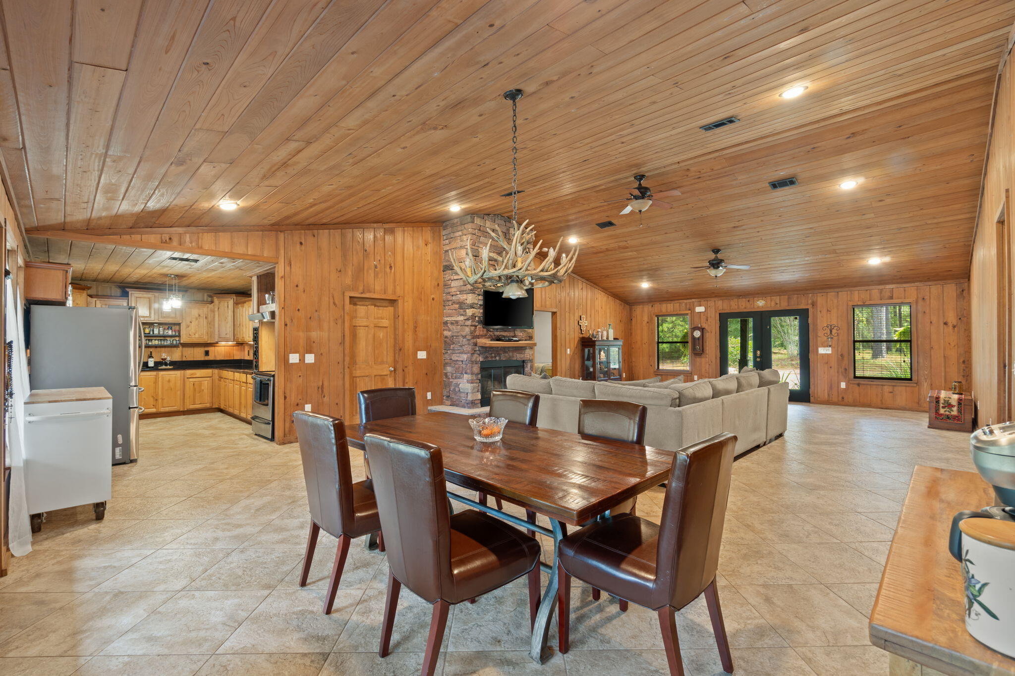 3350 New Ebenezer Road Laurel Hill, FL 32567 - Photo 11 of 53 a dining room with furniture a chandelier and wooden floor
